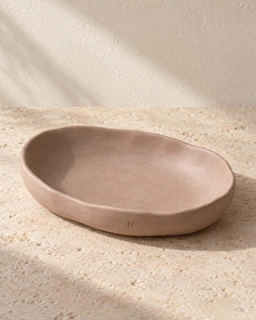 NOSTOS concept ritual dish, photographed on warm limestone.